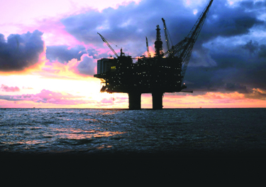 Offshore oil platform at sunset