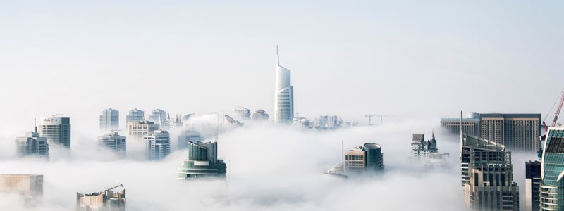 Buildings and skypscrapers surrounded by clouds