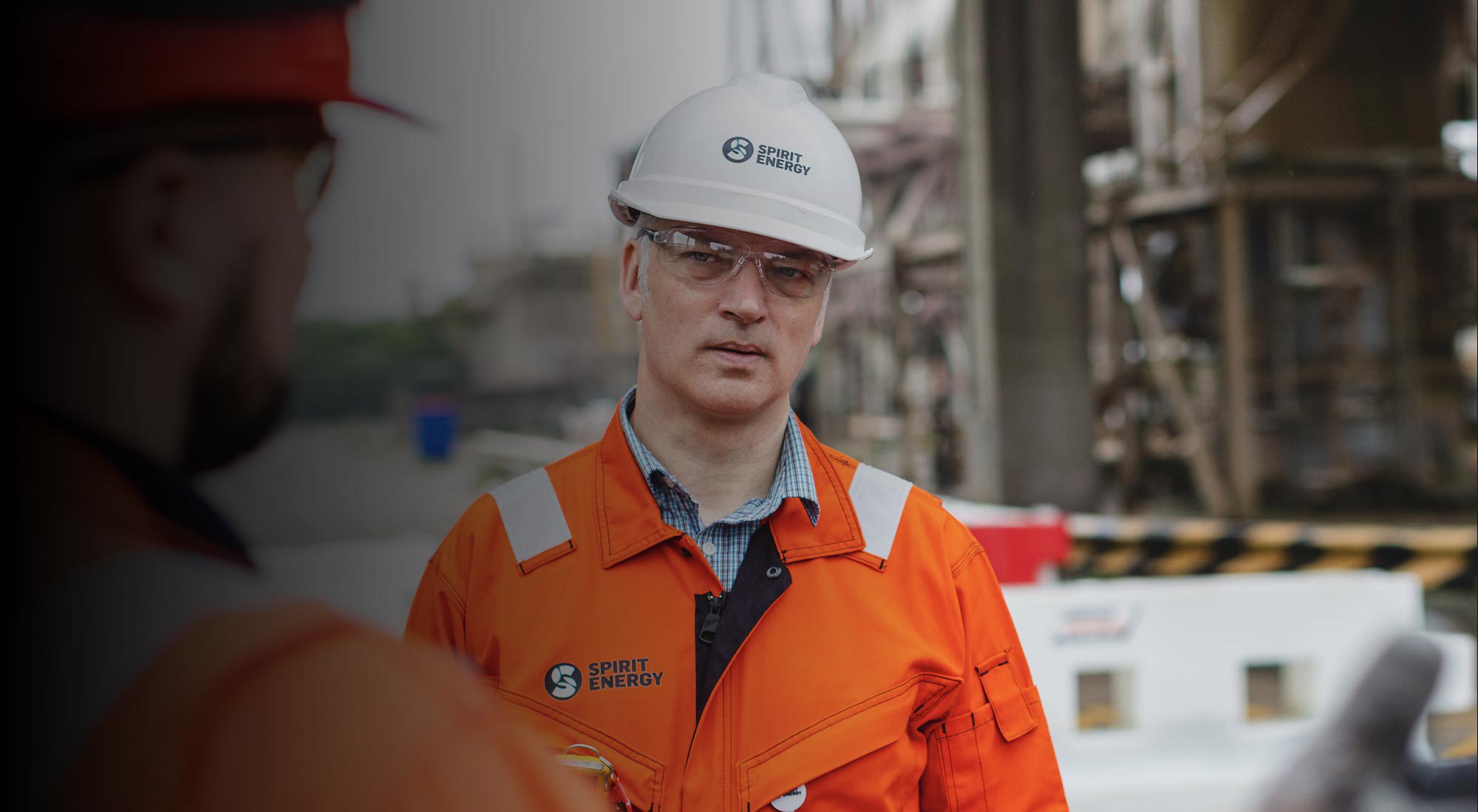 Spirit Energy Employee in safety helmet and orange overall
